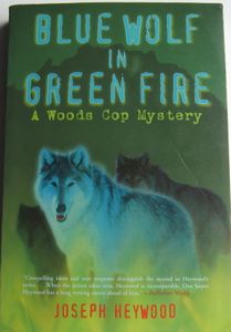 Blue Wolf In Green Fire (A Woods Cop Mystery)